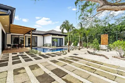 a backyard with a pool and a house at CU27 New Construction 3bdrm Home with Prv Pool in Tamarindo
