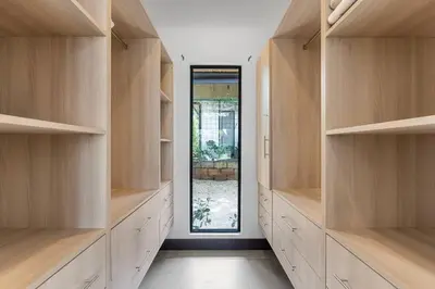 a large room with wooden shelves and a window at CU28 New 3 Bdrm Home w Pool and Guanacaste Tree in Tamarindo
