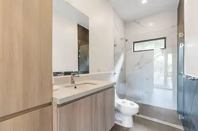 a bathroom with a sink and a toilet and a shower at CU28 New 3 Bdrm Home w Pool and Guanacaste Tree in Tamarindo