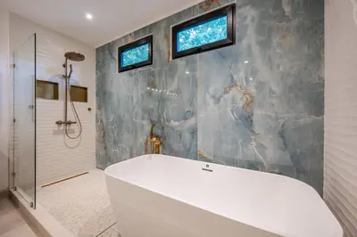 a bathroom with a white tub and a shower at Modern New Villa in Playa Potrero Close to Beach in Potrero