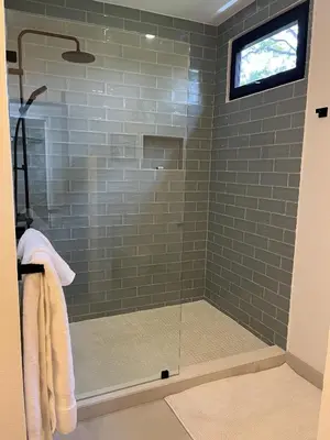 a bathroom with a shower with a glass door at Modern New Villa in Playa Potrero Close to Beach in Potrero