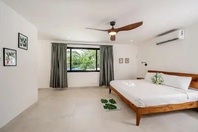 a bedroom with a bed and a ceiling fan at Modern New Villa in Playa Potrero Close to Beach in Potrero