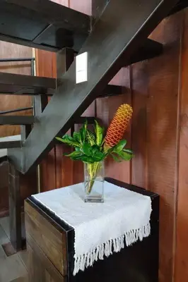 a vase with a carrot in it on a table at Aventura Familiar Bosque Tropical Volcán Arenal in San Ramón