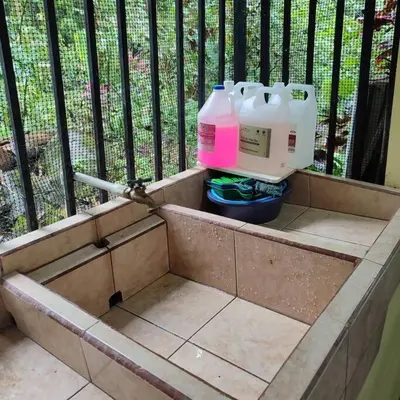 a container with three milk bottles sitting on a balcony at Aventura Familiar Bosque Tropical Volcán Arenal in San Ramón