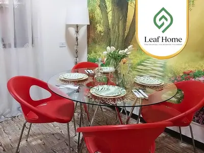 a glass table with red chairs in a room at Alajuela Leaf Home in Alajuela City