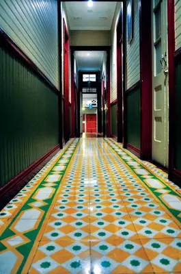 a hallway with a colorful tile floor in a building at Hotel Aranjuez in San José