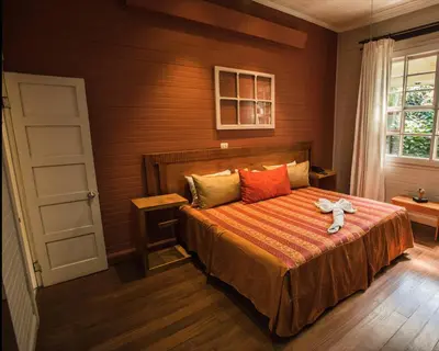 a bedroom with a bed with a teddy bear on it at Hotel Aranjuez in San José