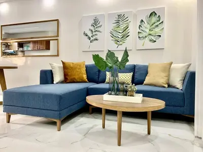 a blue couch in a living room with a table at Gav10 Modern Pool Side Condo in Quiet Area of Tam in Tamarindo