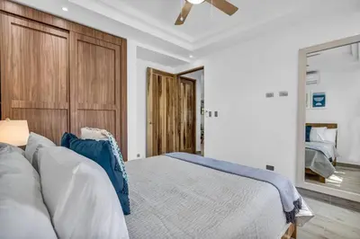 a bedroom with a bed and a ceiling fan at Gav4 New Condo in Location Walkable to Beach in Tamarindo