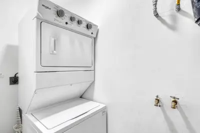 a white kitchen with a white stove top oven at Gav4 New Condo in Location Walkable to Beach in Tamarindo