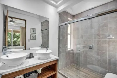 a bathroom with two sinks and a shower at Gav4 New Condo in Location Walkable to Beach in Tamarindo