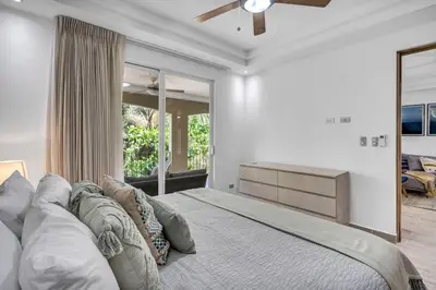 a bedroom with a large bed and a large window at Gav4 New Condo in Location Walkable to Beach in Tamarindo