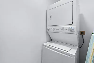 a white refrigerator with its door open in a kitchen at Gav5 New Modern Condo Walking Distance to Beach in Tamarindo