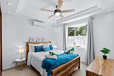 a bedroom with a bed with two stuffed animals on it at Gav5 New Modern Condo Walking Distance to Beach in Tamarindo