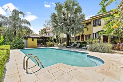 a swimming pool in front of a house at LSI1 Cozy 2 Bdrm Villa Central and Steps to Beach in Tamarindo