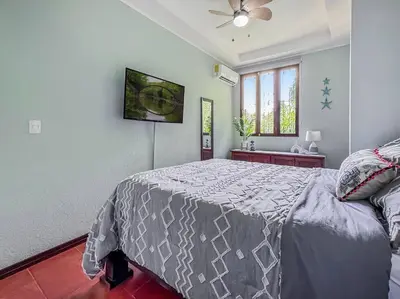 a bedroom with a bed and a ceiling fan at LSI1 Cozy 2 Bdrm Villa Central and Steps to Beach in Tamarindo