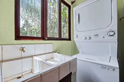 a kitchen with a sink and a washer and dryer at LSI1 Cozy 2 Bdrm Villa Central and Steps to Beach in Tamarindo