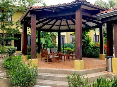 a patio with an umbrella and a table and chairs at LSI1 Cozy 2 Bdrm Villa Central and Steps to Beach in Tamarindo