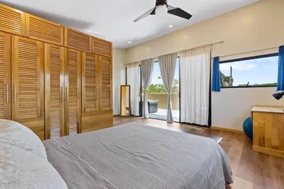 a bedroom with a bed and a ceiling fan at Matambú Main House in Cuajiniquil
