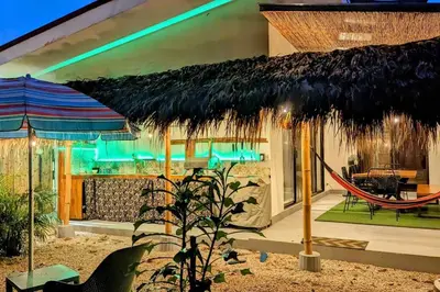 a resort with a hammock and a large umbrella at Matambú Main House in Cuajiniquil