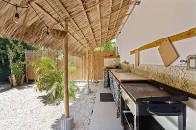 a patio with a table and an umbrella at Matambú Main House in Cuajiniquil