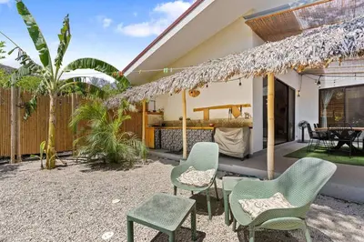 a patio with chairs and a table and a fence at Matambú Main House in Cuajiniquil