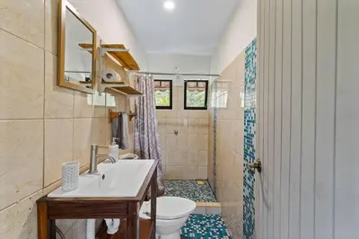 a bathroom with a sink and a toilet at Matambu Entire Complex in Cuajiniquil