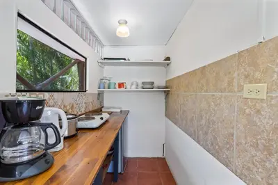 a small kitchen with a counter and a mixer at Matambu Entire Complex in Cuajiniquil