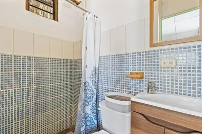 a bathroom with a toilet and a sink and a shower at Matambu Entire Complex in Cuajiniquil