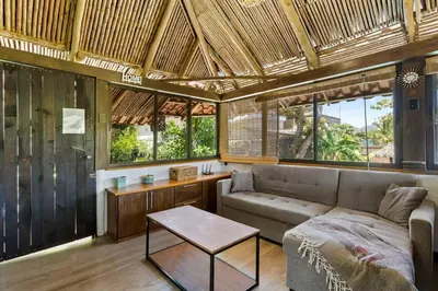 a living room with a couch and a table at Matambú Rancho Rustic 2bd Apt with Shared Pool in Matapalo