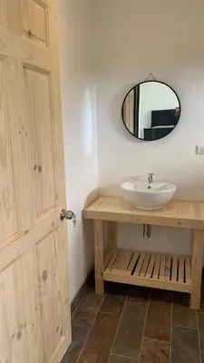 a bathroom with a sink and a mirror at sarahs peaceful Home in Parrita