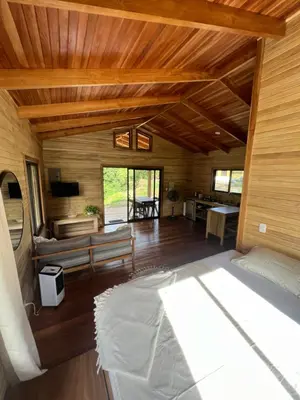 a large room with a bed and a living room at Almond Suite - Blue Zone Costa Rica, Hojancha in Caimital