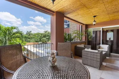 a cat sitting on a table on a patio at Nax3 Luxury Condo in Upscale Langosta Community in Tamarindo