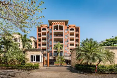 a large building with a gate in front of it at Nax3 Luxury Condo in Upscale Langosta Community in Tamarindo