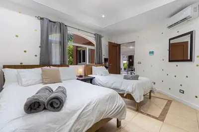 a bedroom with two beds with towels on them at Nax3 Luxury Condo in Upscale Langosta Community in Tamarindo