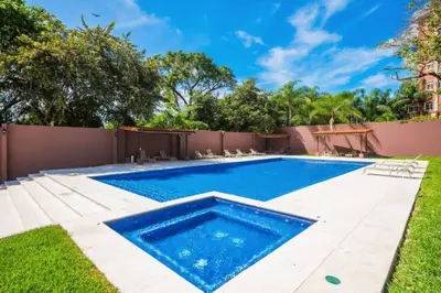 a swimming pool in the backyard of a house at Pen16 Luxury 3bd Condo in Excl Resort Complex in Tamarindo