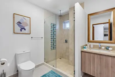 a bathroom with a shower and a toilet and a sink at Pen16 Luxury 3bd Condo in Excl Resort Complex in Tamarindo
