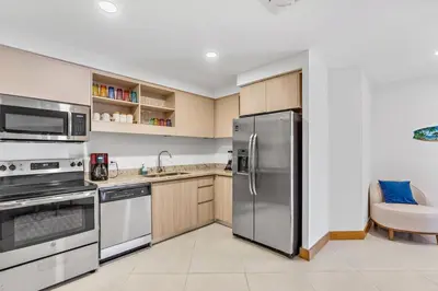a kitchen with a stainless steel refrigerator and appliances at Pen16 Luxury 3bd Condo in Excl Resort Complex in Tamarindo