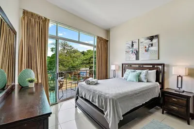 a bedroom with a bed and a large window at PP201 Modern Space in Centre of Town in Tamarindo