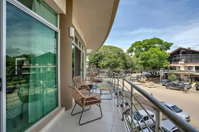 a row of chairs sitting on a balcony at PP201 Modern Space in Centre of Town in Tamarindo