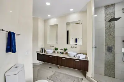 a bathroom with two sinks and a shower at PP201 Modern Space in Centre of Town in Tamarindo