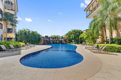 a swimming pool in the middle of a resort at SR9 Luxury Condo Across the Street from Beach in Tamarindo