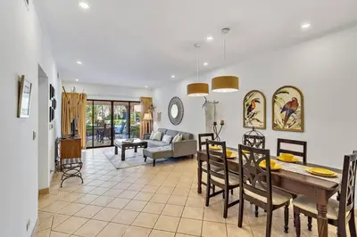 a dining room and living room with a table and chairs at SR9 Luxury Condo Across the Street from Beach in Tamarindo