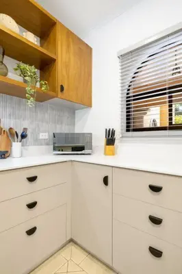 a kitchen with white cabinets and a window at SR9 Luxury Condo Across the Street from Beach in Tamarindo