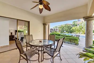 a dining room with a glass table and chairs at SR9 Luxury Condo Across the Street from Beach in Tamarindo