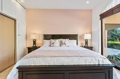 a bedroom with a large bed with two lamps at SR9 Luxury Condo Across the Street from Beach in Tamarindo