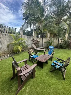 a group of picnic tables and chairs in a yard at VBM1 Beachside Cottage Steps from the Shore in Tamarindo