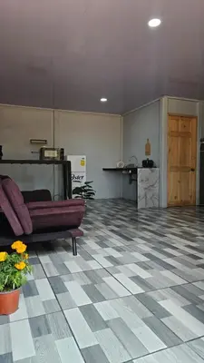 a living room with a couch and a checkered floor at Rincón del Sol in Upala