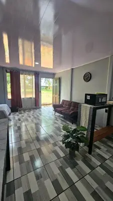 a living room with a couch and a table at Rincón del Sol in Upala