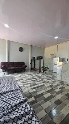 a living room with a couch and a checkered floor at Rincón del Sol in Upala